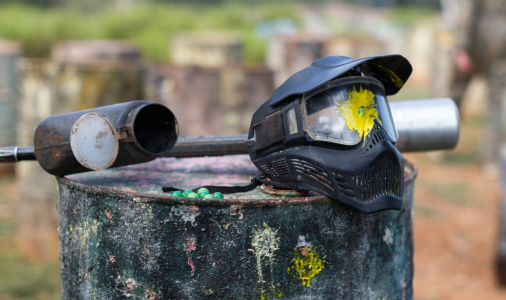 paintball mask with gun next to it