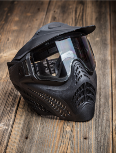 black paintball mask on wood