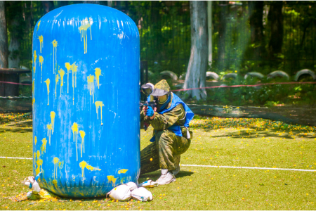 paintball player behind blow up cover
